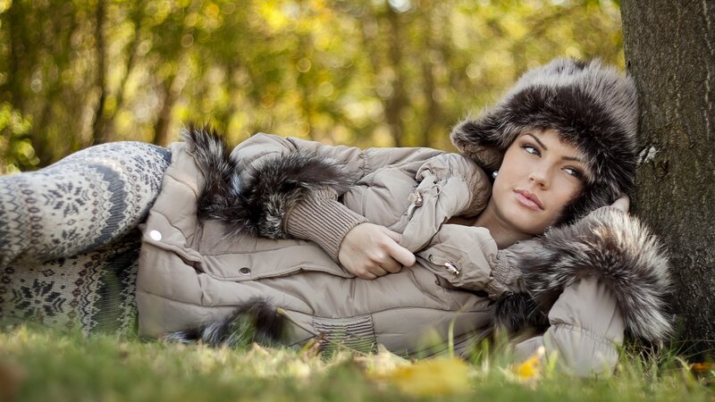 Woman in winter coat resting