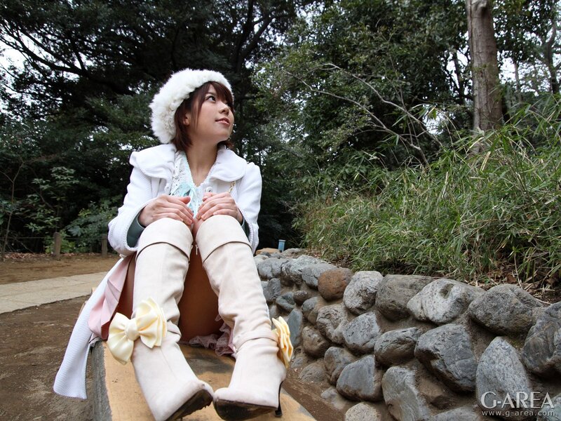 woman in winter coat sitting outdoors