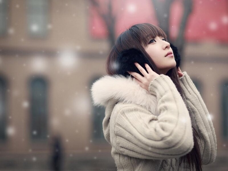 woman in winter coat with earmuffs
