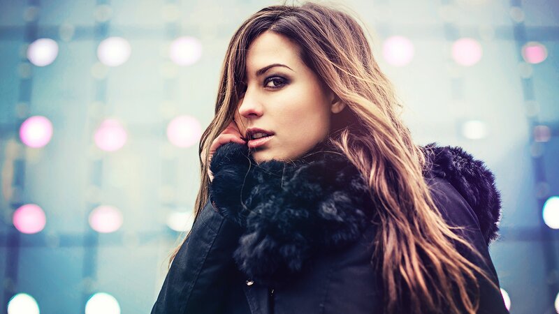 woman in winter coat with lights