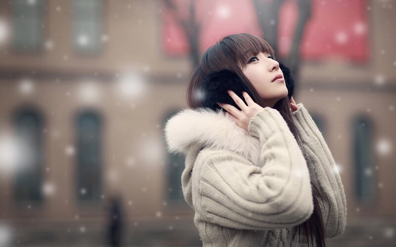 woman in winter coat with snow