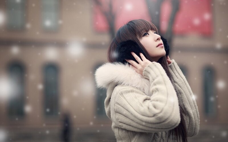 woman in winter coat with snow