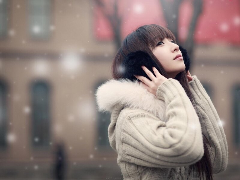 woman in winter coat with snow