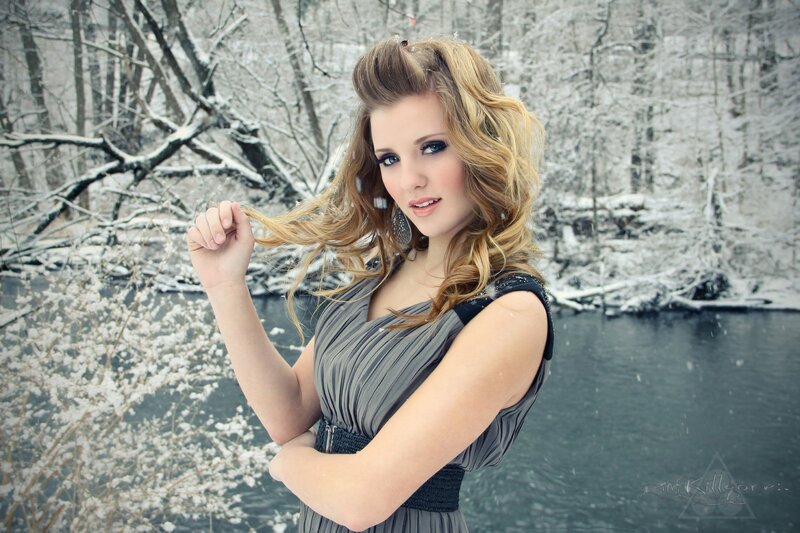 woman in winter dress by river