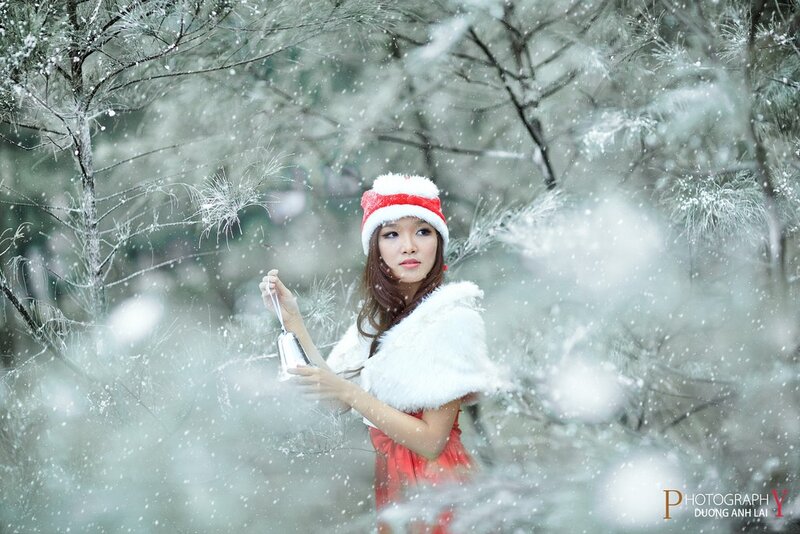 woman in winter forest with bells