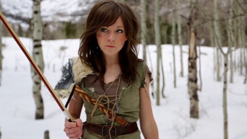 woman in winter forest with bow