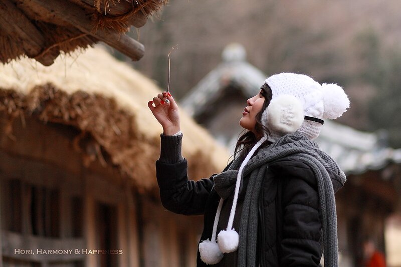 woman in winter hat holding straw