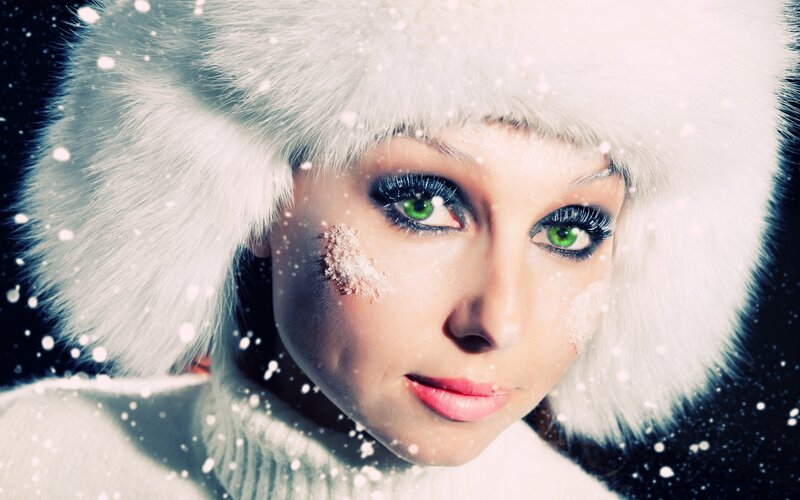 woman in winter hat with snow