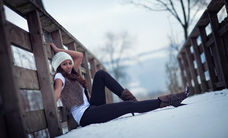 Woman in winter on a snowy bridge