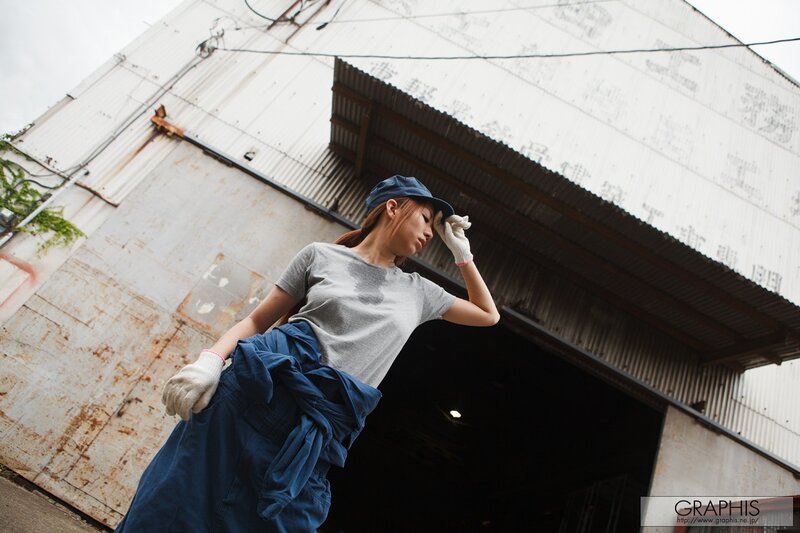 woman in work clothes outside warehouse