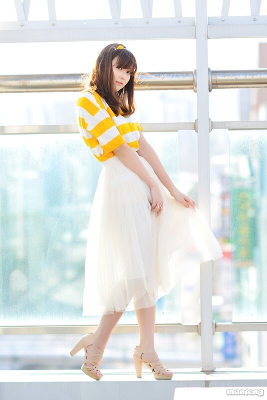 Woman in yellow and white dress