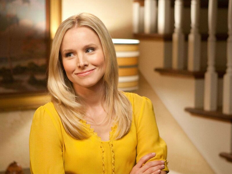 woman in yellow blouse smiling