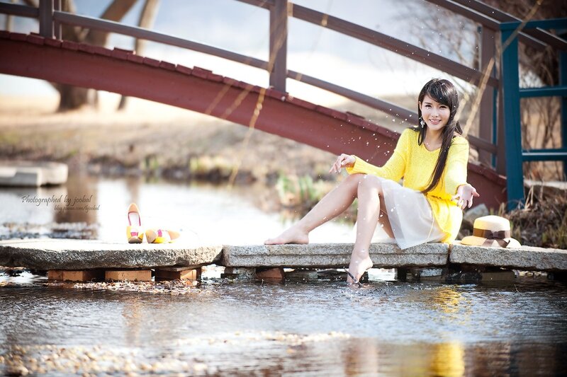 Woman in yellow by the water
