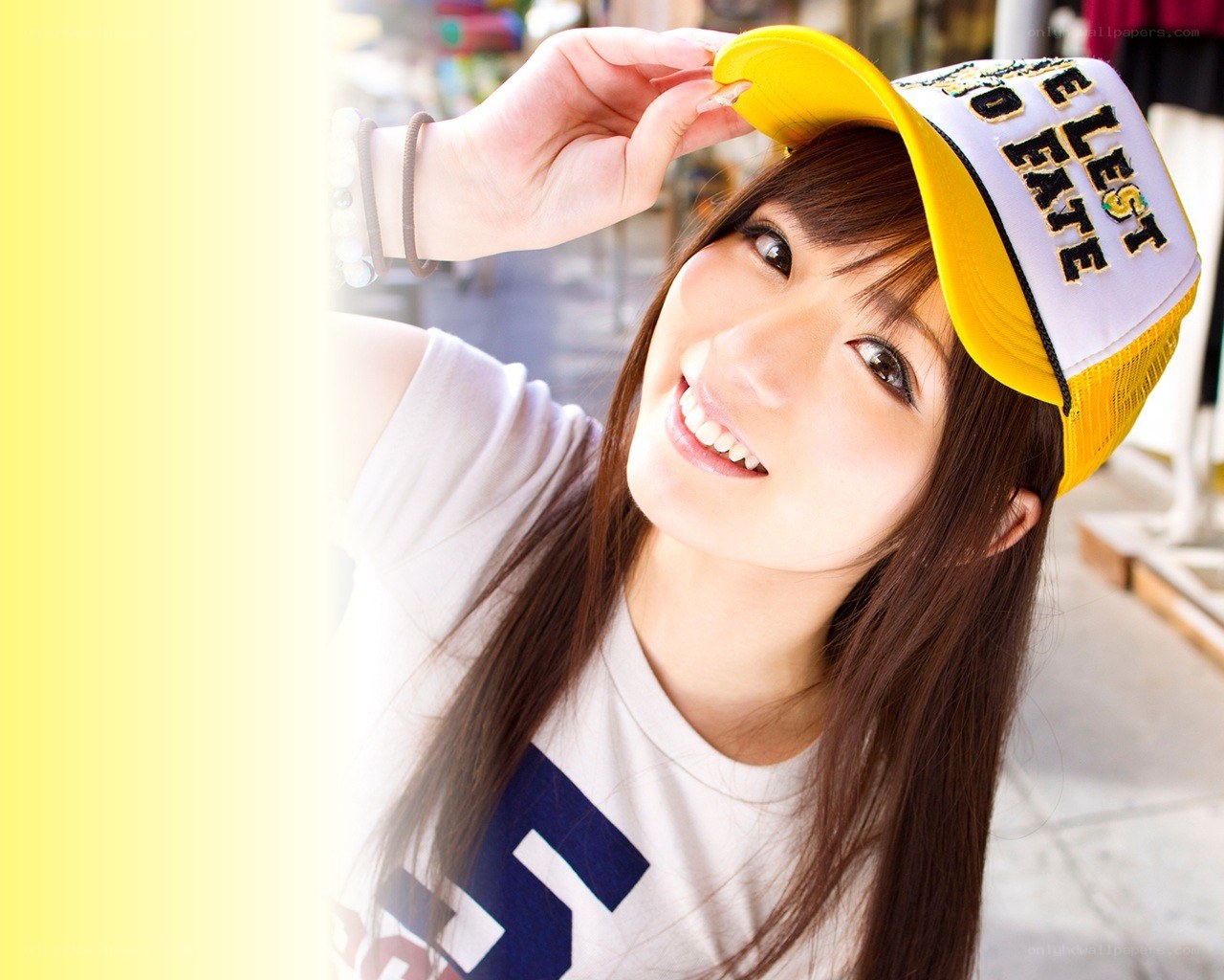 woman in yellow cap smiling