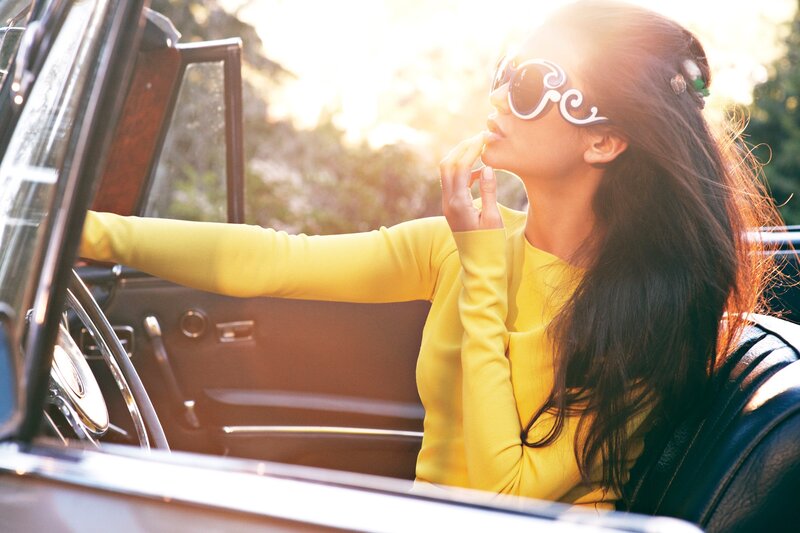 woman in yellow car at sunset