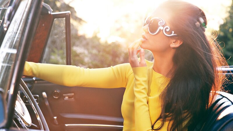 woman in yellow car at sunset
