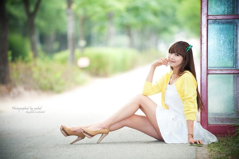 woman in yellow cardigan sitting