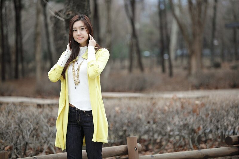 woman in yellow coat outdoors