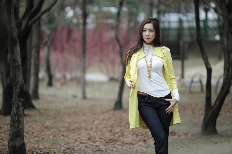 woman in yellow coat outdoors
