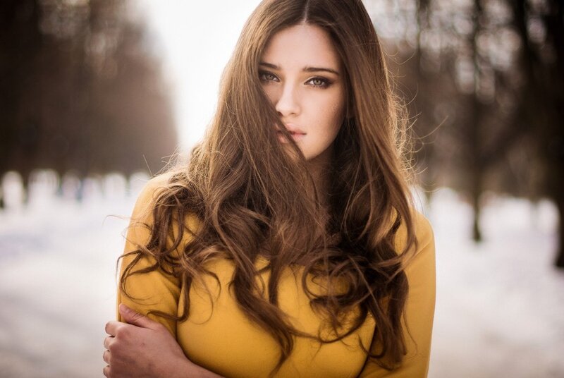 woman in yellow coat outdoors