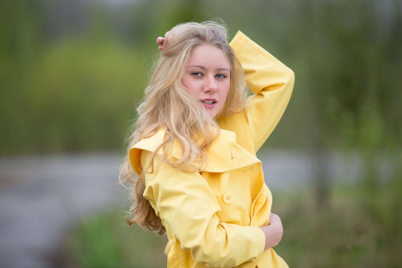 woman in yellow coat outdoors