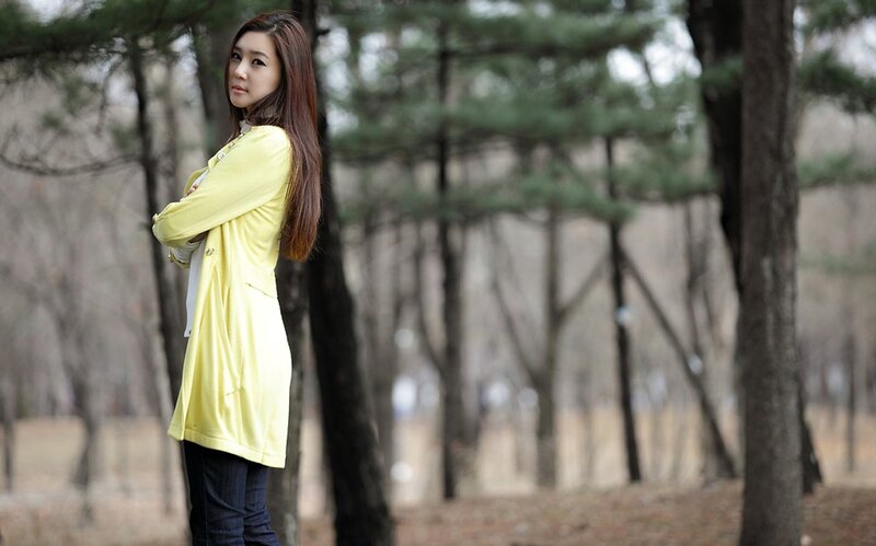 woman in yellow coat outdoors