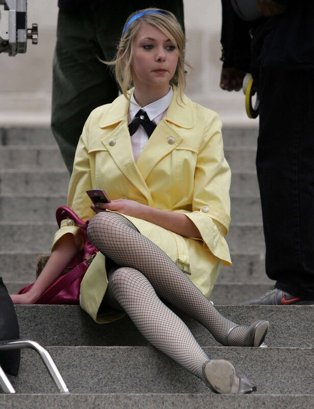 woman in yellow coat sitting on steps