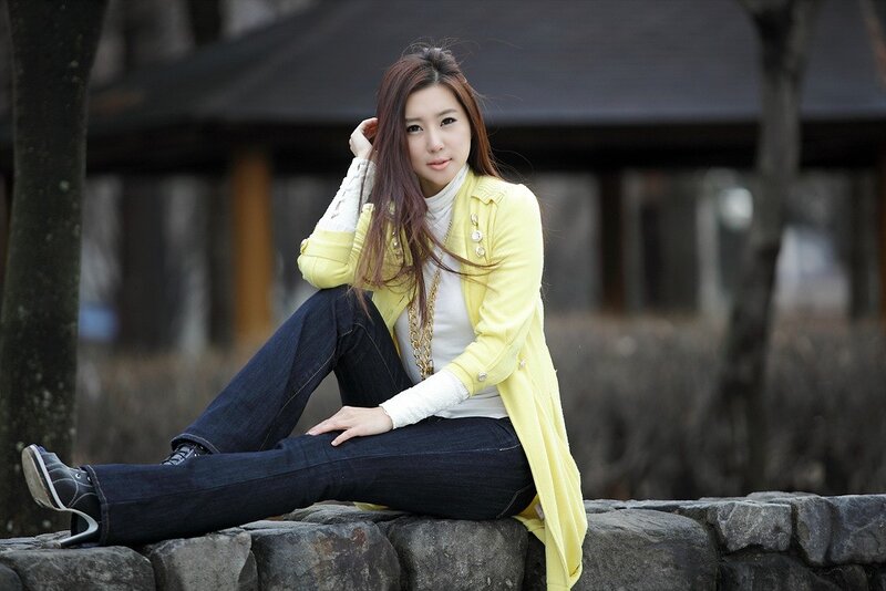 woman in yellow coat sitting