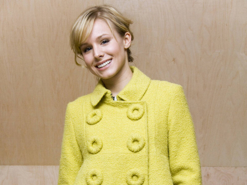woman in yellow coat smiling