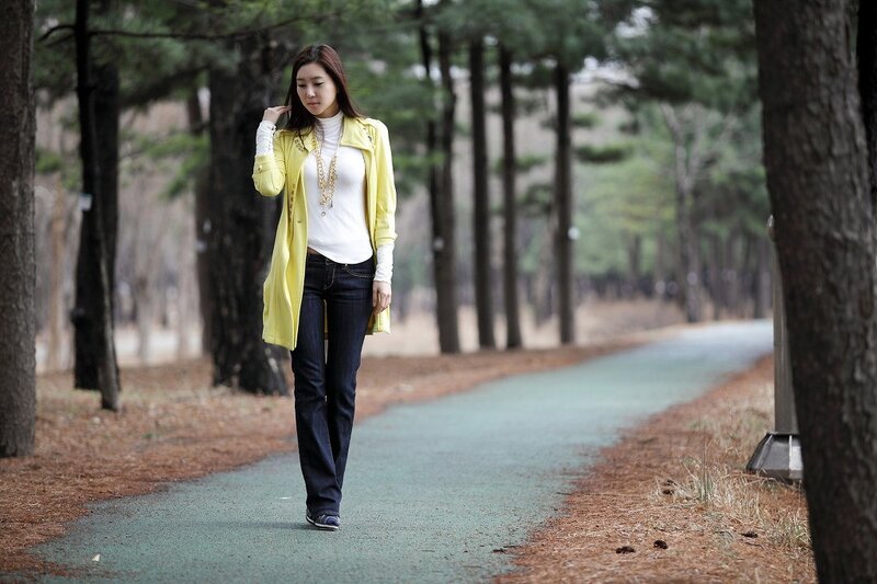 Woman in yellow coat walking