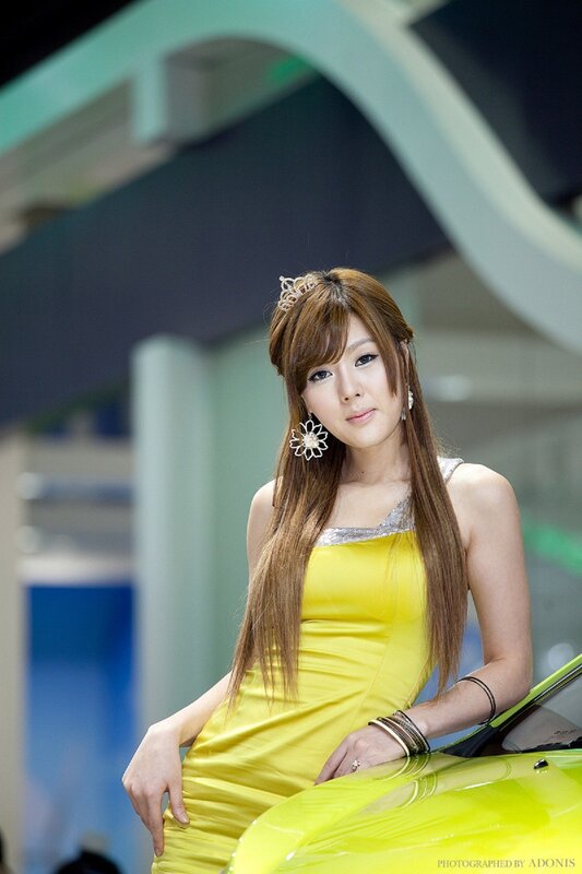 Woman in yellow dress at auto show