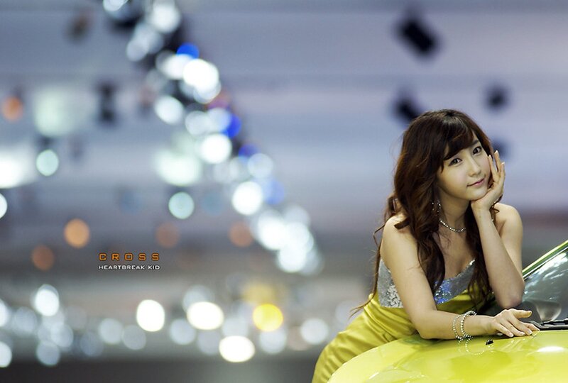 woman in yellow dress at auto show