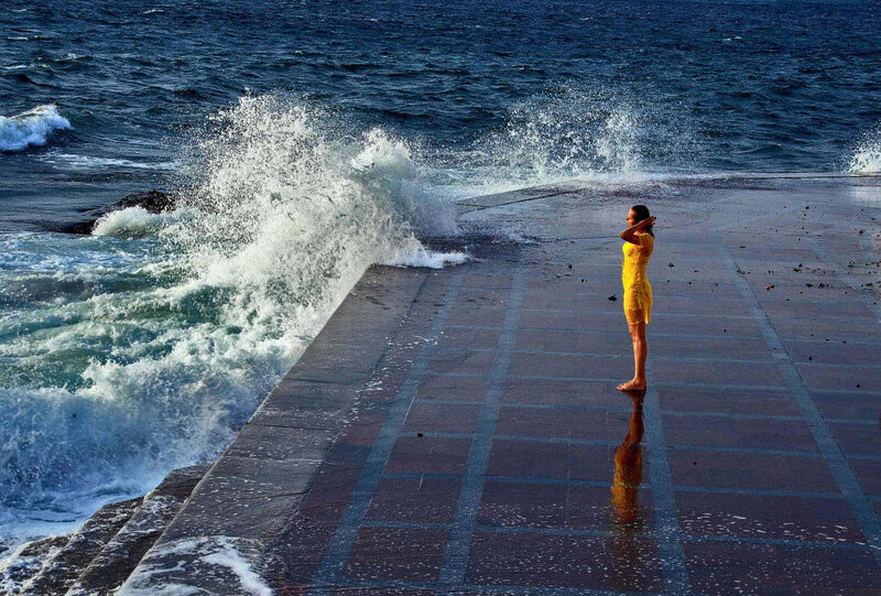 Woman in yellow dress by the sea