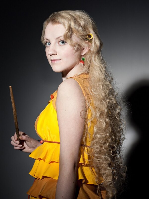 Woman in yellow dress holding wand