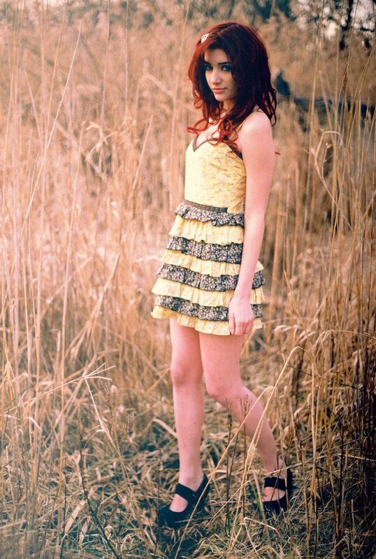 Woman in yellow dress in field