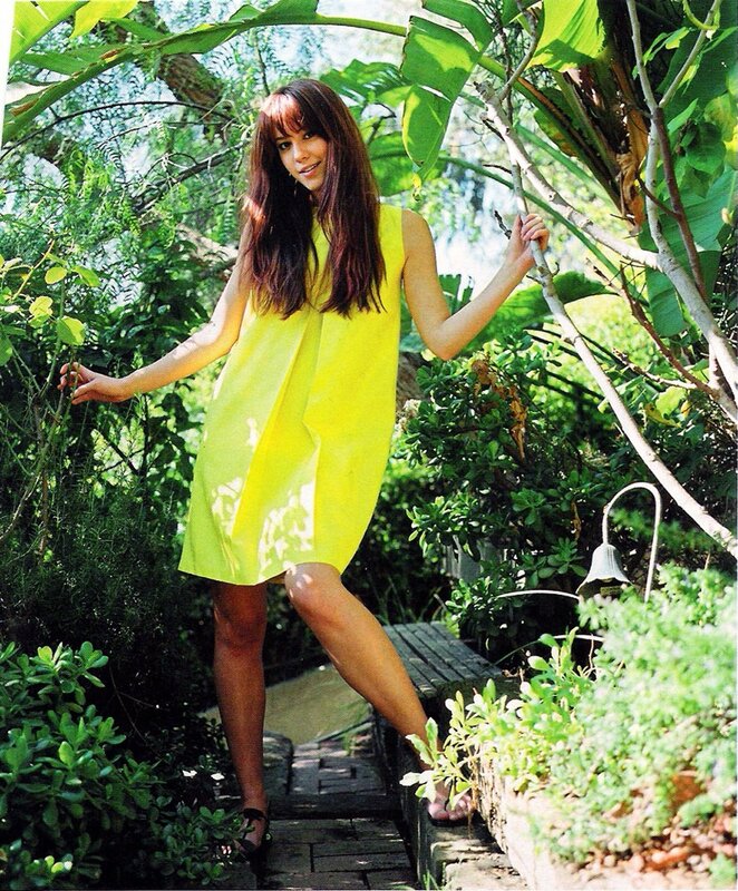 Woman in yellow dress in garden