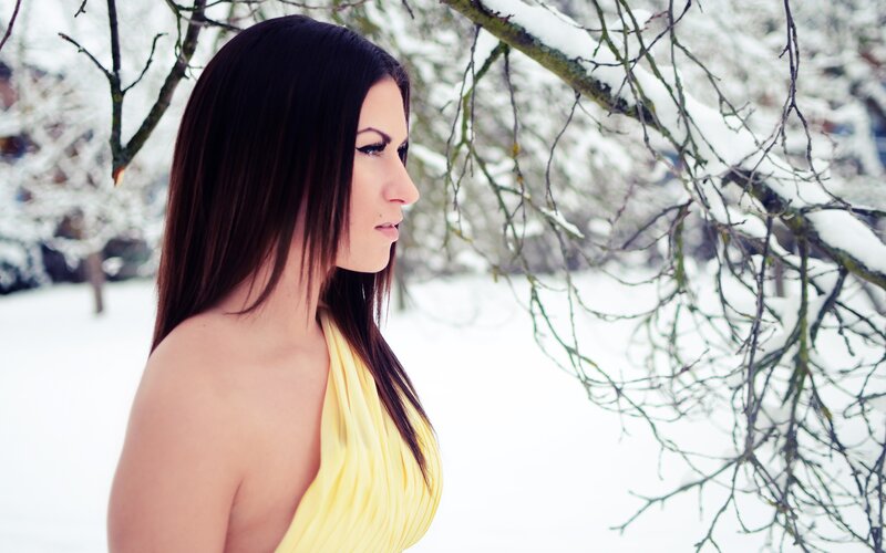woman in yellow dress in snow