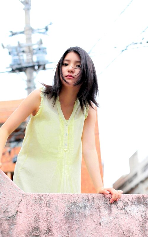 woman in yellow dress on balcony