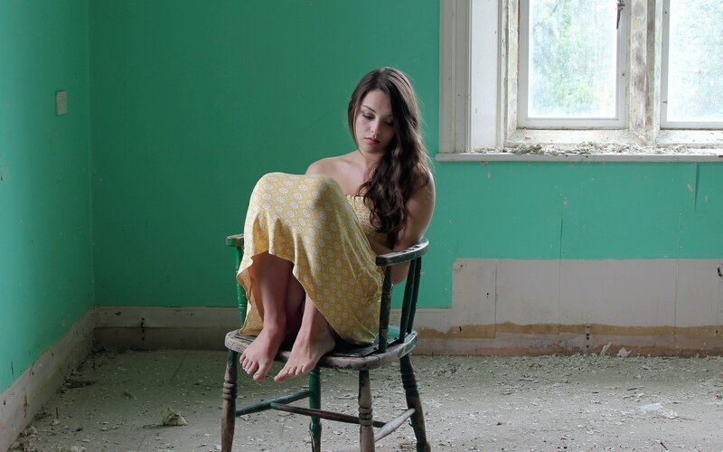 Woman in yellow dress on chair