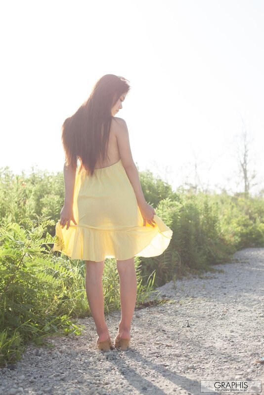 Woman in yellow dress on path
