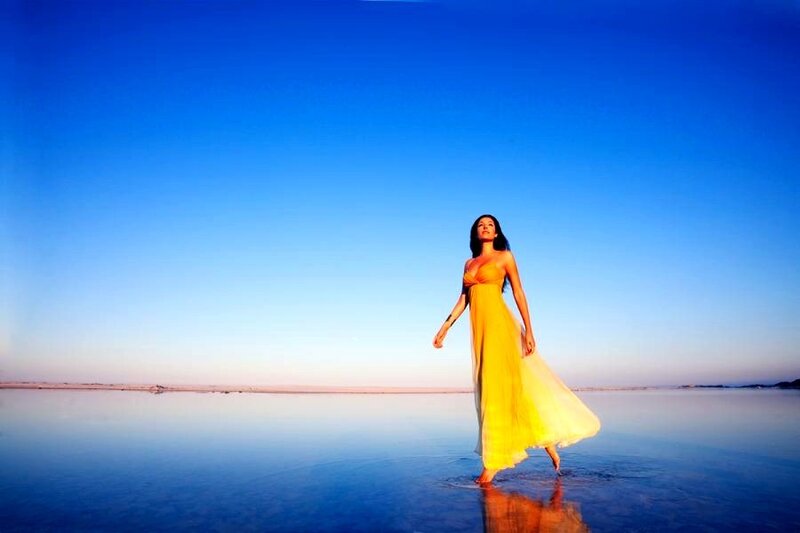 Woman in yellow dress on salt flat