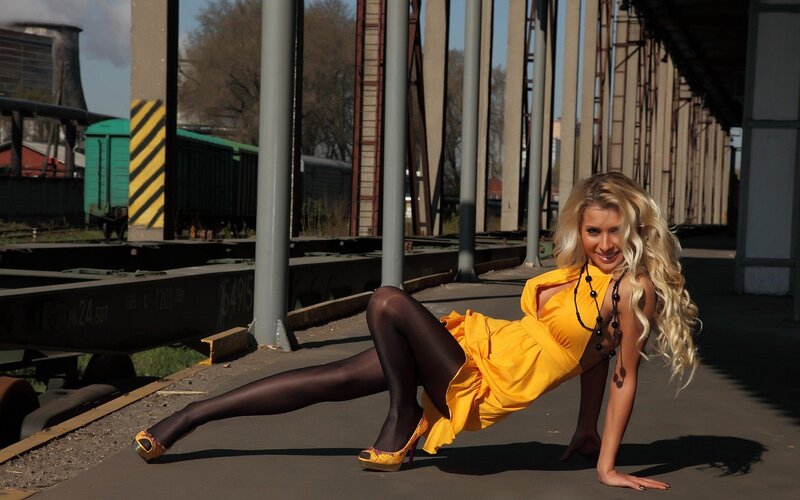 Woman in yellow dress on train platform