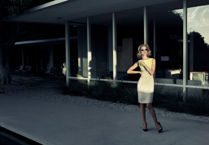 Woman in yellow dress outside modern house