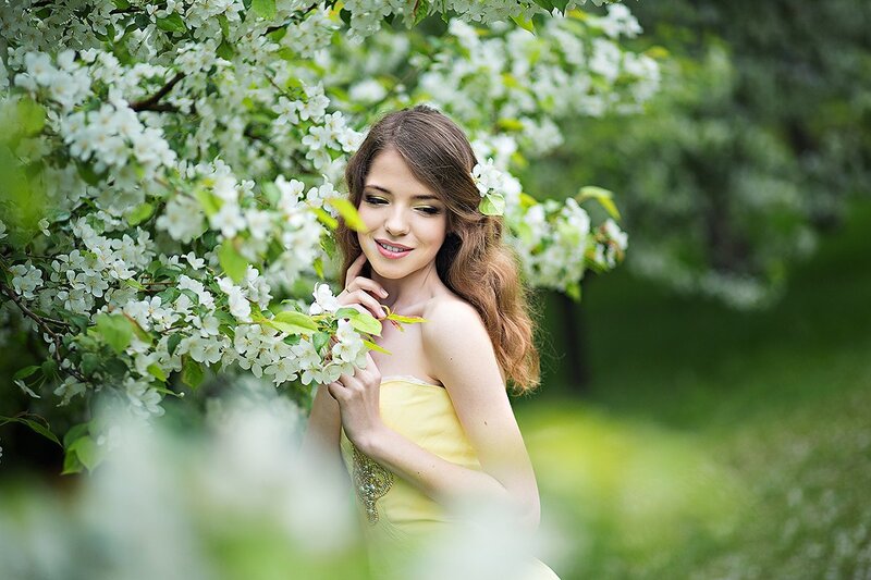 Woman in Yellow Dress — Serene, Spring, Photograph, White Flowers, Green Leaves