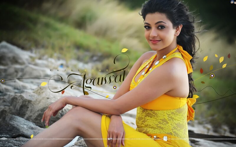 Woman in yellow dress sitting on rocks