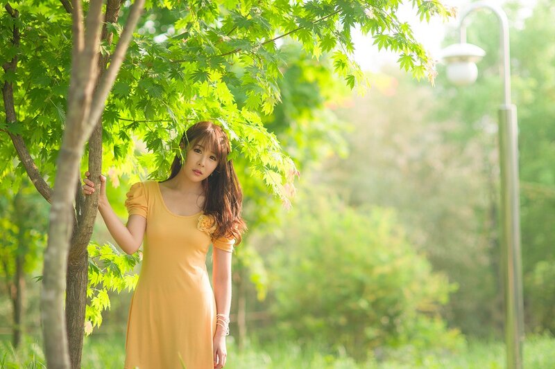 woman in yellow dress under tree