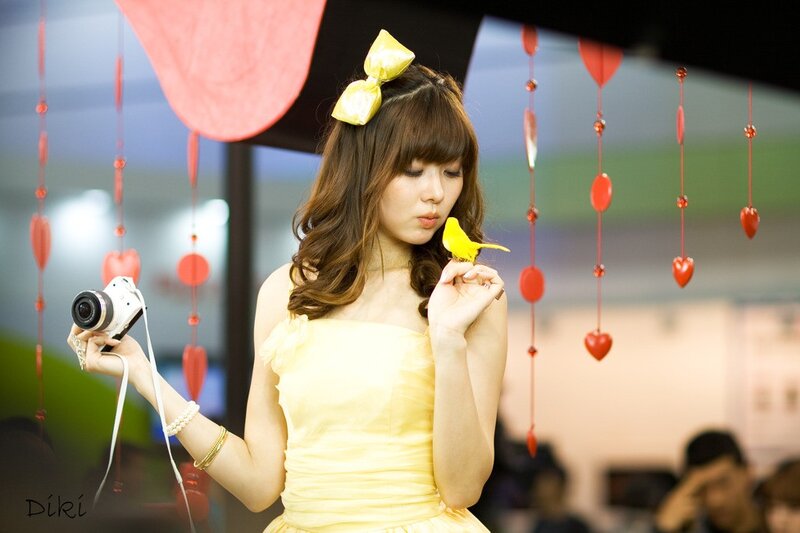 Woman in yellow dress with camera