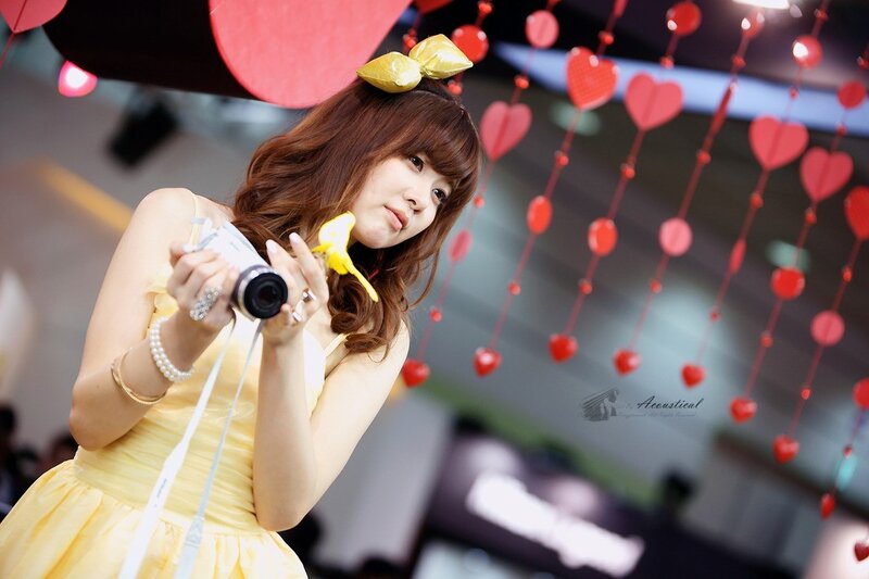 Woman in yellow dress with camera