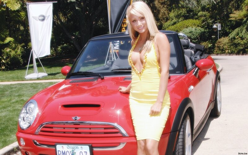 Woman in yellow dress with red car