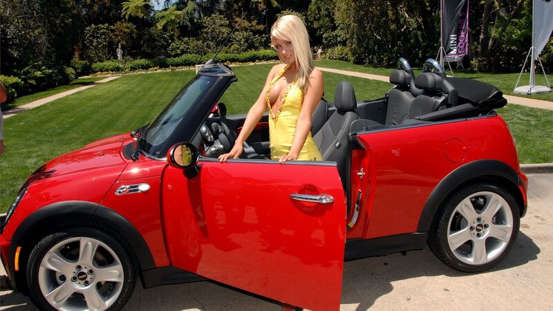 Woman in yellow dress with red convertible